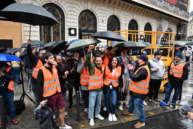 Apple employees demonstrate in front of the Apple Store near the Paris Opera on September 22, 2023.