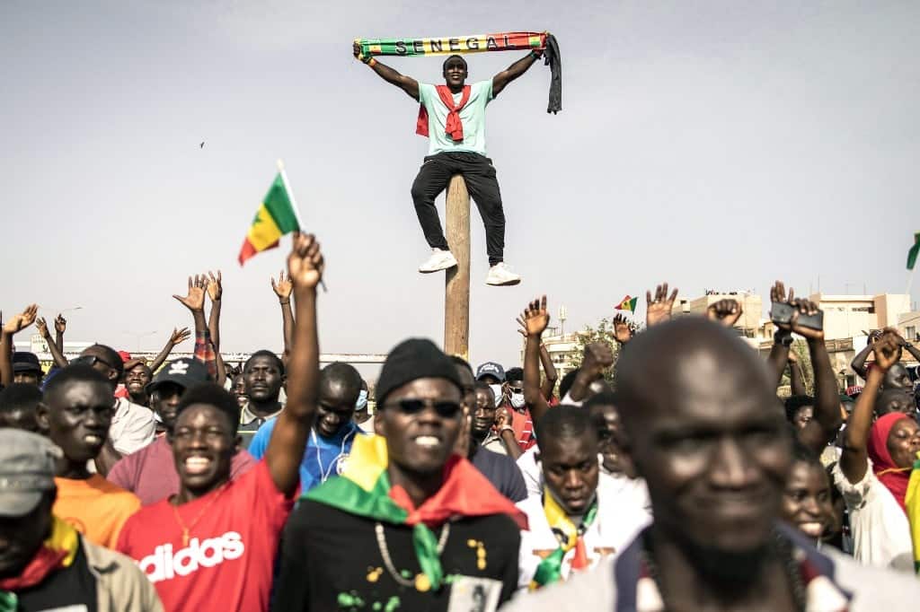Supporters of the Movement for the Defense of Democracy (M2D) react during a demonstration in Dakar, June 23, 2021, to mark the 10th anniversary of the 2011 protests that called for an end to the former's possible third term.  -President Abdoulaye Wade and to denounce the possible third term of the current president Macky Sall.  JOHN WESSELS/AFP